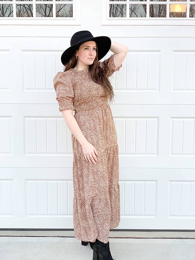 Reviewer is wearing a clay and white dotted tiered maxi dress