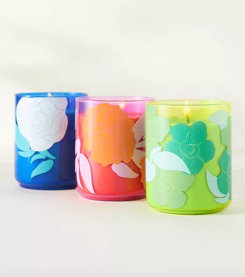 blue, pink, and green candles with floral motifs