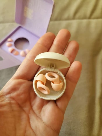 reviewer photo of the peach-colored earplugs in their case