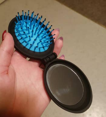 reviewer holding the extended brush and mirror