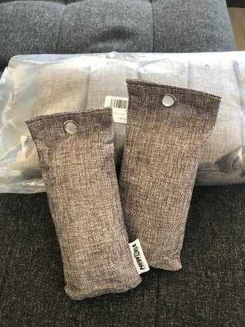 reviewer photo of two of the gray odor eliminating bags