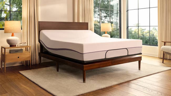 Adjustable furniture successful a modern chamber with a raised headrest, brushed lighting, and ample windows showing a presumption of trees
