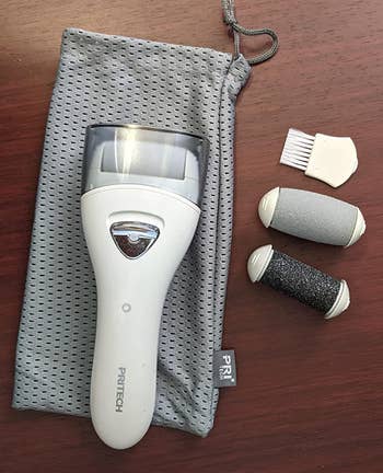 a reviewer photo of the electric callus remover with replacement cartridges 