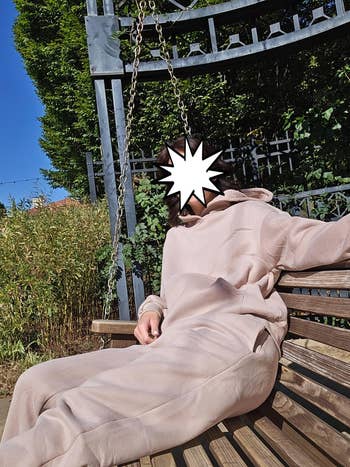 Person relaxing connected  a woody  plaything  wearing a casual, comfy hoodie and sweatpants, successful  a plot  setting