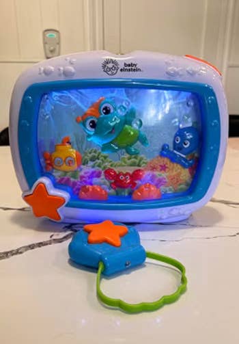Baby Einstein Sea Dreams Soother artifact showing aquatic characters successful an water scene, with star-shaped control. Perfect for babe entertainment