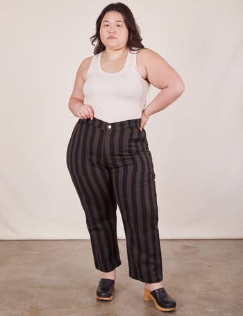 Model wearing espresso pants with black stripes
