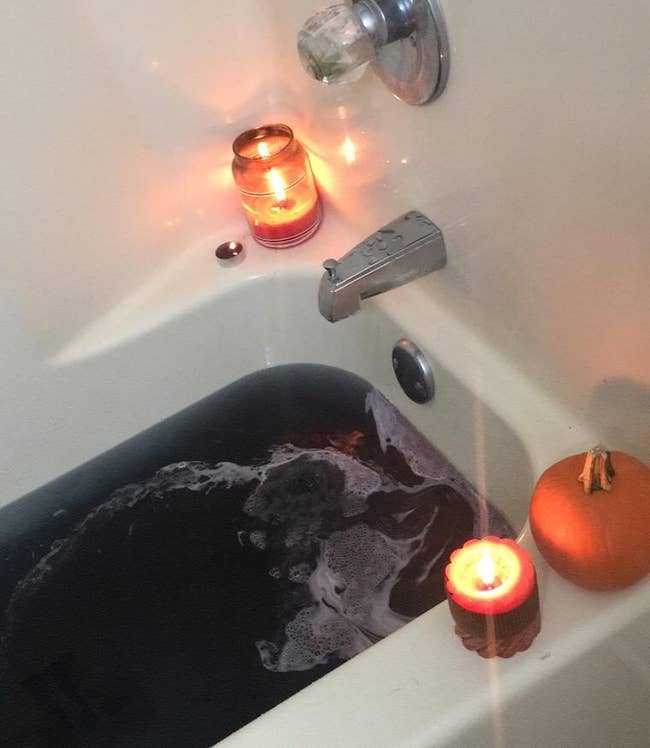 tub filled with iridescent black water