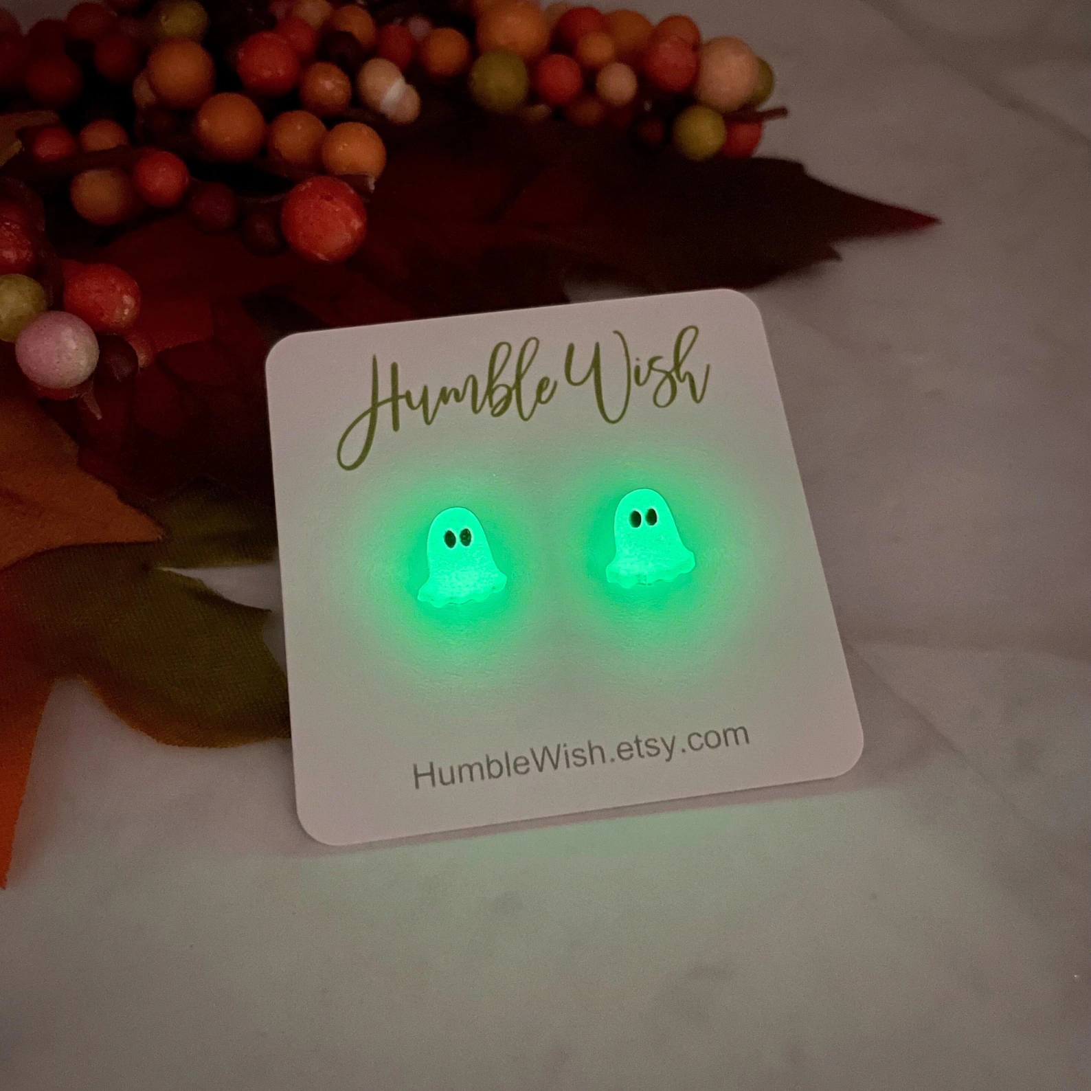 Glow-in-the-dark shade  earrings connected  a paper  with 