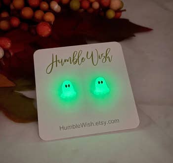 Glow-in-the-dark shade earrings connected a paper with