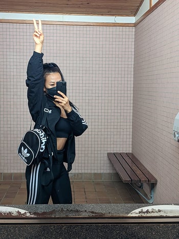 reviewer mirror selfie wearing black mini Adidas backpack