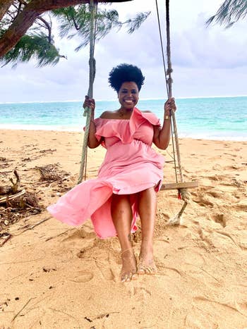 reviewer in the pink dress on a swing