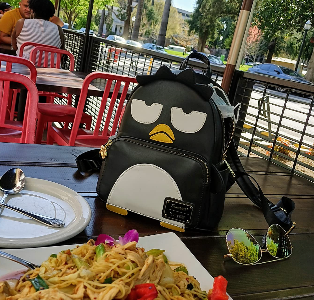 Reviewer photo of the bag on a table next to a plate of noodles