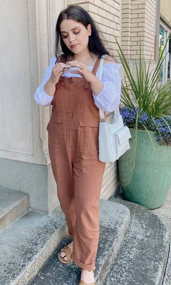 reviewer wearing the brown jumpsuit