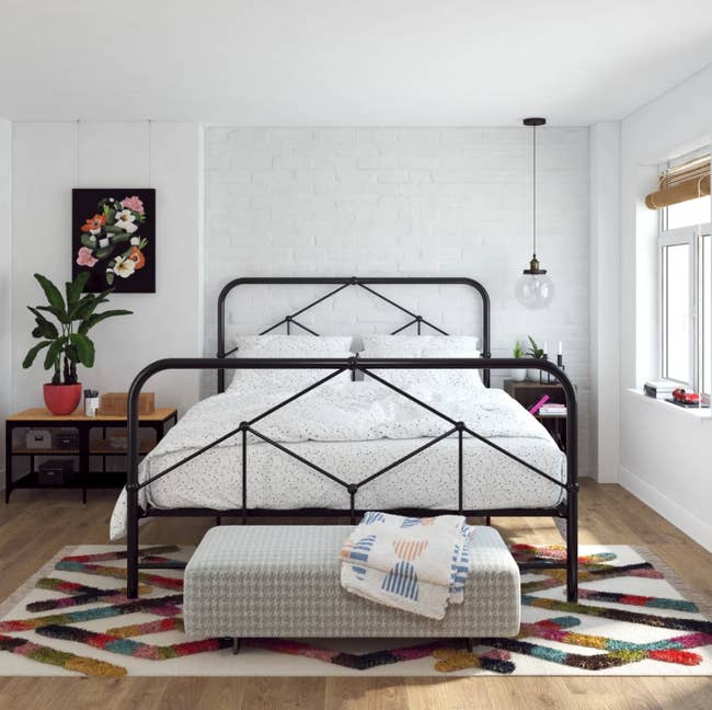 the black metal bed in a room 