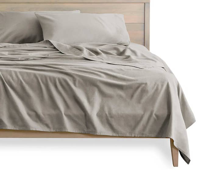 a bed with grey flannel sheets