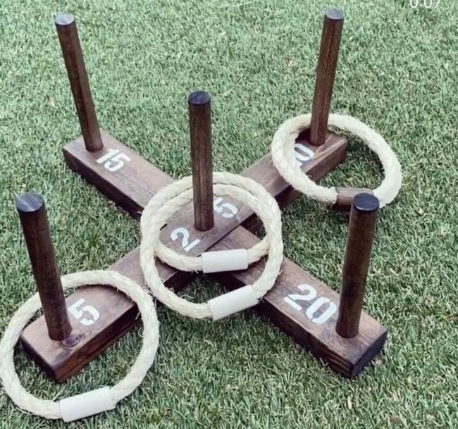 the dark brown stained ring toss game with six rope rings
