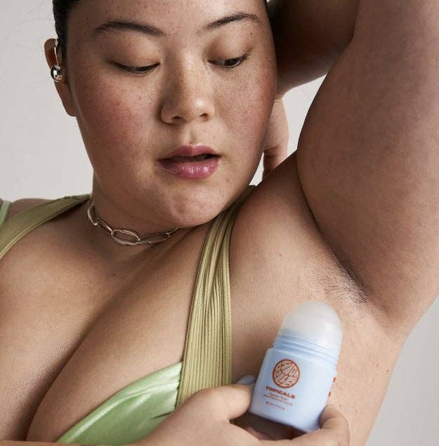 Person applying the ingrown tonic to their underarm, wearing a sleeveless top