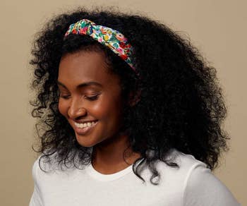 a model wearing a floral headband