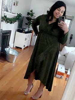 reviewer wearing the dark green dress with beige heels