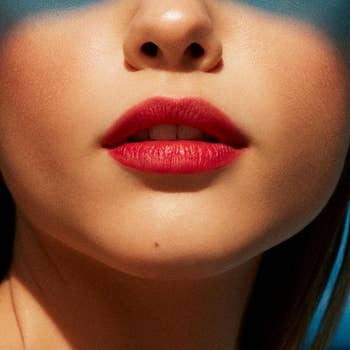 model wearing the reddish-pink lip stain