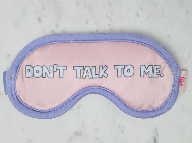light pink and lavender eye mask that says 