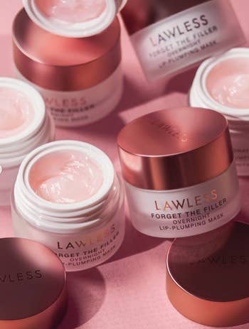 Several open jars of Lawless Forget The Filler, an overnight lip-plumping mask, displayed aesthetically