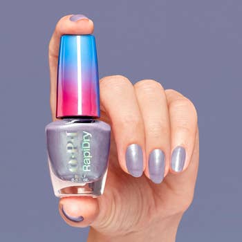 Hand displaying airy  purple nail polish