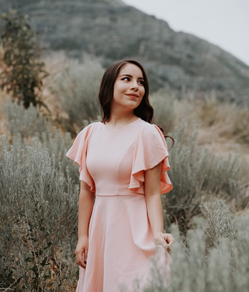 reviewer wearing the light pink dress