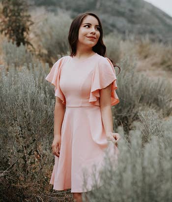 reviewer wearing the light pink dress