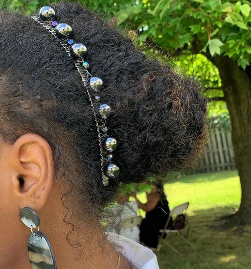 beaded clip in a reviewer's hair holding it in an updo