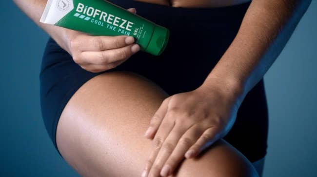 model rubbing Biofreeze gel on thigh