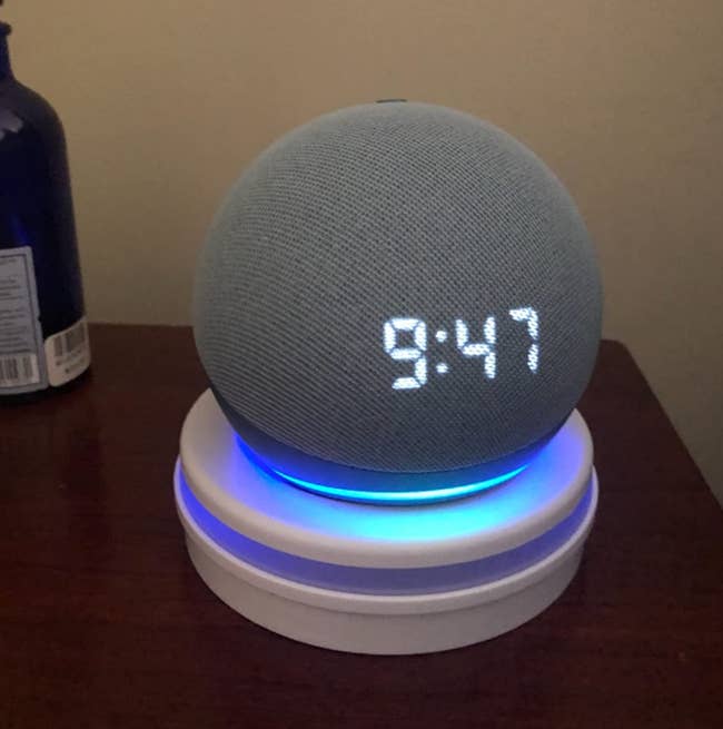 reviewer image of the round Echo Dot on their bedside table