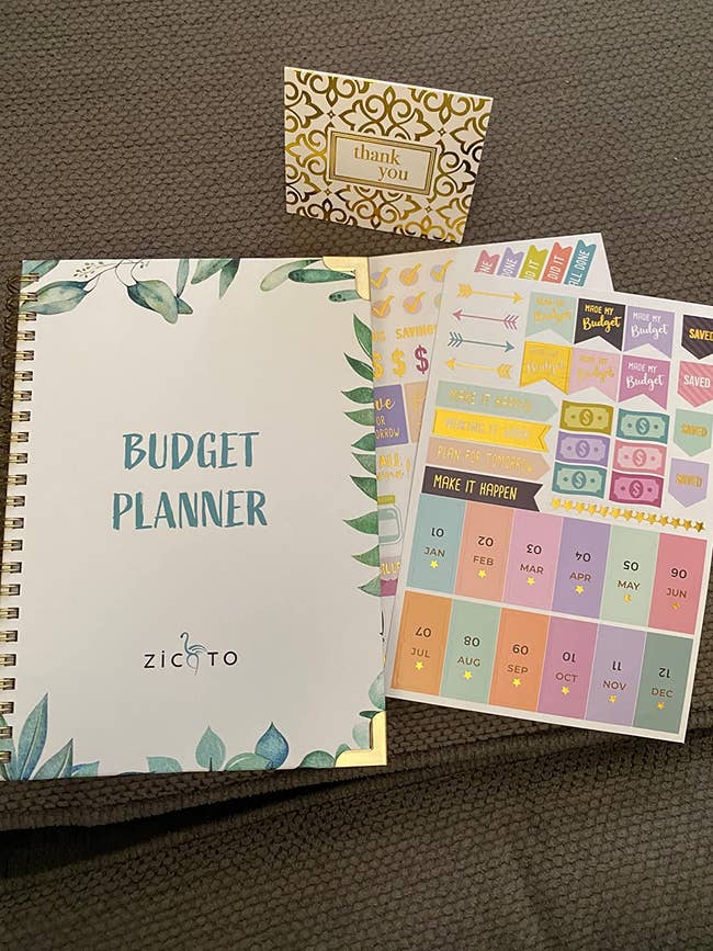 reviewer's budget planner with gold and green detail and sticker sheets