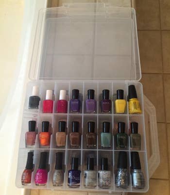 A reviewer's clear nail polish organizer open and filled with polishes