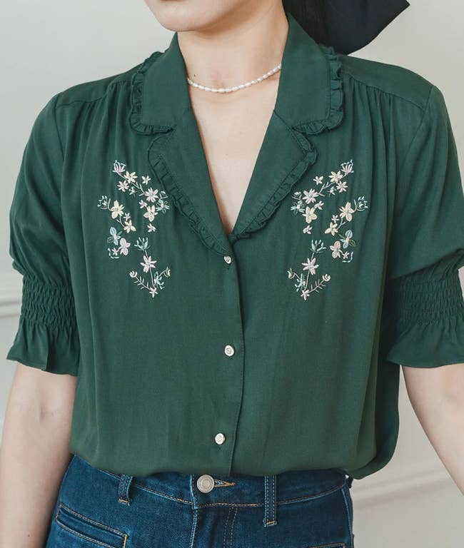 model wearing the green floral embroidery blouse