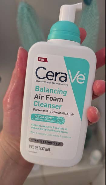 Person holding a vessel  of CeraVe Balancing Air Foam Cleanser, with details connected  hydration and lipid  power  for mean   to operation  skin