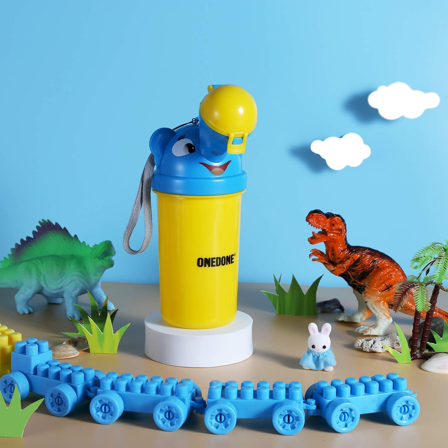 The travel urinal surrounded by toys