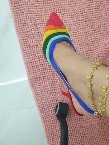 reviewer in rainbow stripe pointy toe stilettos 