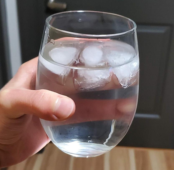 Reviewer holding the glass with ice in it