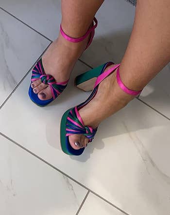 a reviewer wearing the shoes in pink, purple, green, and blue 