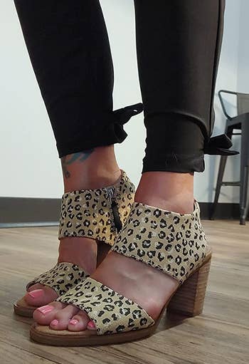 reviewer wearing the leopard-print sandals