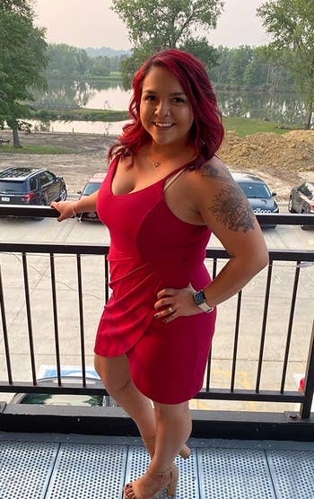 reviewer wearing the bodycon dress in red