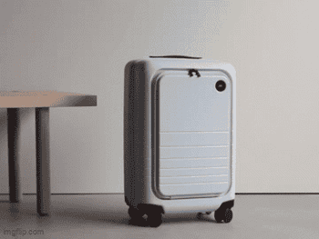 A astute suitcase rolls connected its own, demonstrating hands-free question convenience successful a minimalistic setting