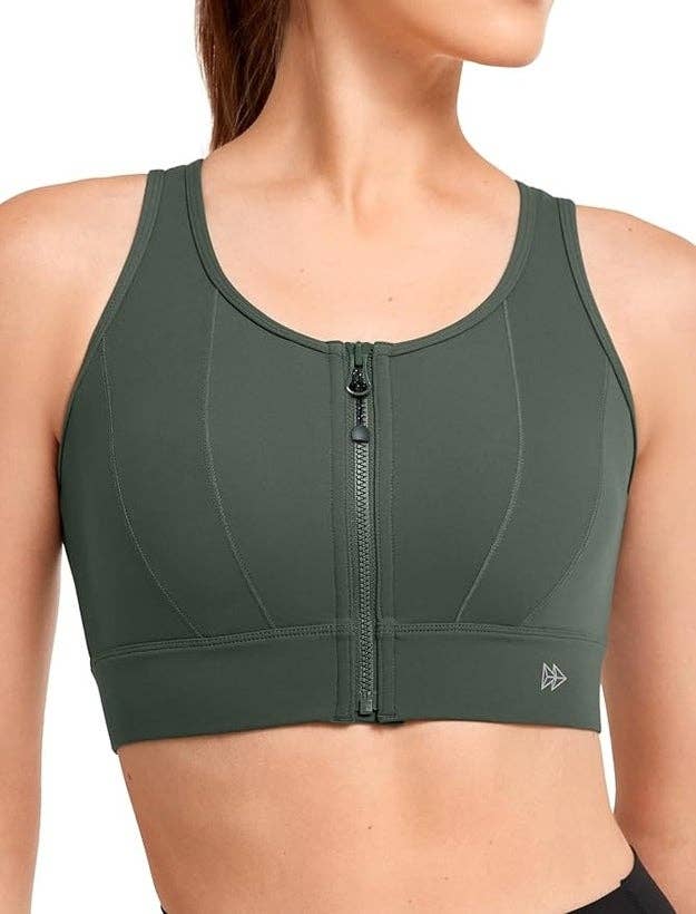 A idiosyncratic   wears a zip-front sports bra with subtle seam details, suitable for progressive  wear