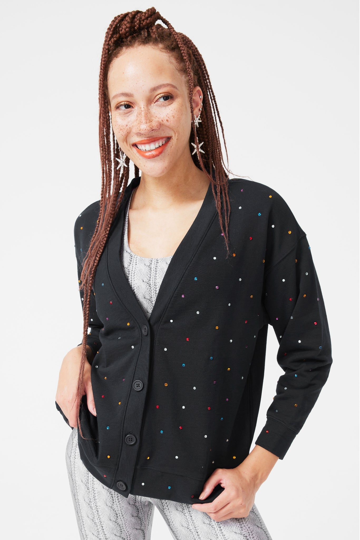 model wearing the black cardigan with small jewels all over it