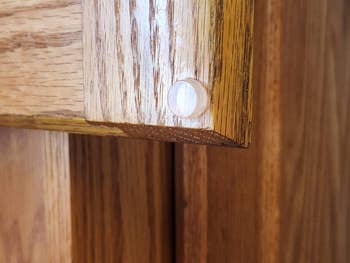 reviewer photo of a round door bumper on a cabinet door