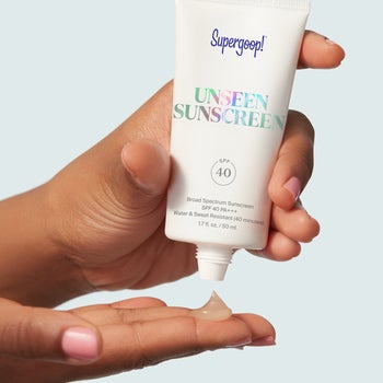 hand squirts the Supergoop! Unseen Sunscreen into palm 