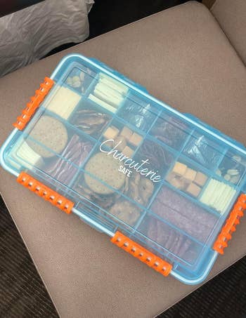 Portable charcuterie snack box with assorted meats and cheeses