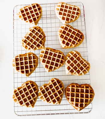 reviewer photo of heart-shaped waffles on a cooling rack