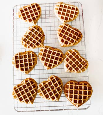 reviewer photo of heart-shaped waffles on a cooling rack